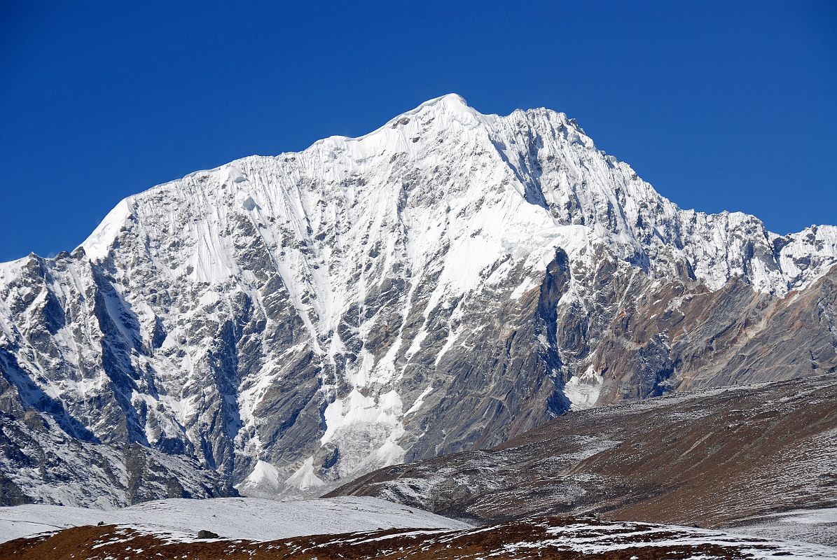 16 Pemthang Karpo Ri Close Up As Trek Nears Shishapangma Advanced Base Camp Pemthang Karpo Ri (6830m, also called Dome Blanc) close up as the trek nears Shishapangma Southwest Advanced Base Camp. The first ascent of Pemthang Karpo Ri was made by the Swiss Raymond Lambert, Ang Norbu Sherpa, Kami Tshering Sherpa, Pasang Sherpa, and Pemba Gyaltzen Sherpa on May 13 (14?), 1955, climbing from the south.